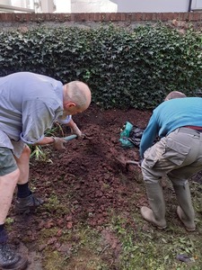 7. Once the hole was filled with rubble and wood we started to backfill - inserting two short drainpipes to give access to the interior.